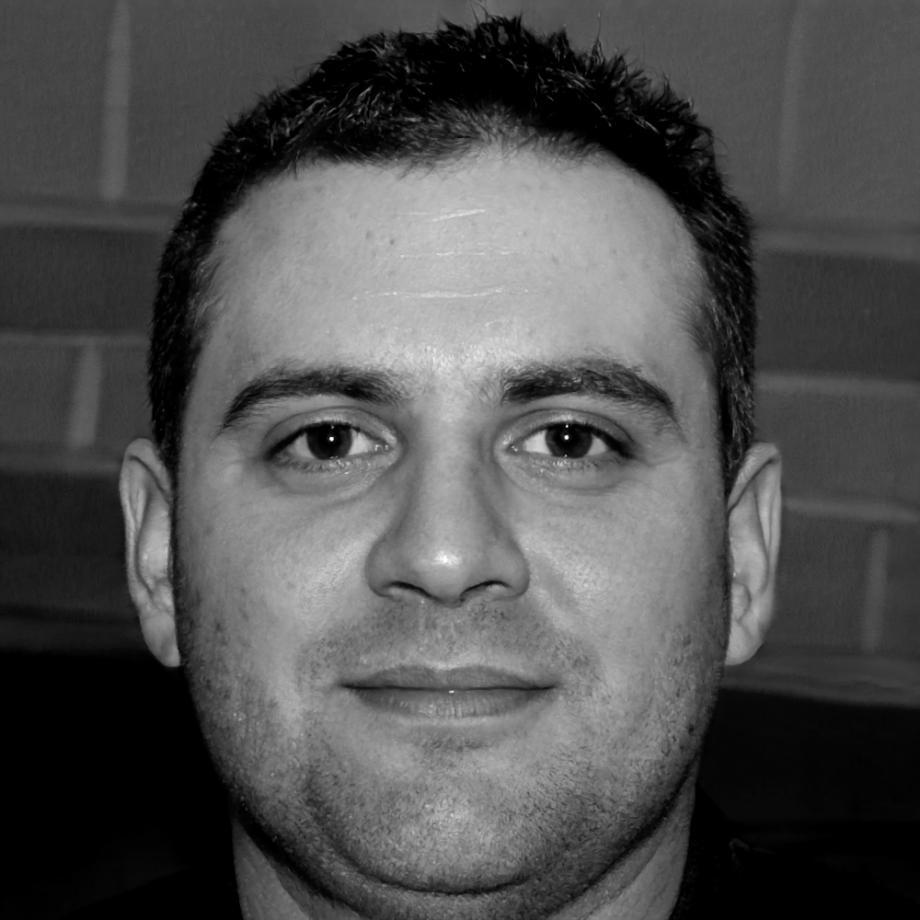 Instructor Declan Rourke reviewing financial communication materials